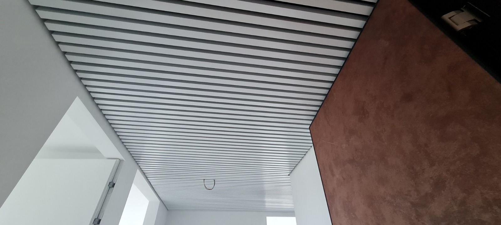 Cube-shaped rail ceilings KRAFT in a prestigious residential complex in Romania